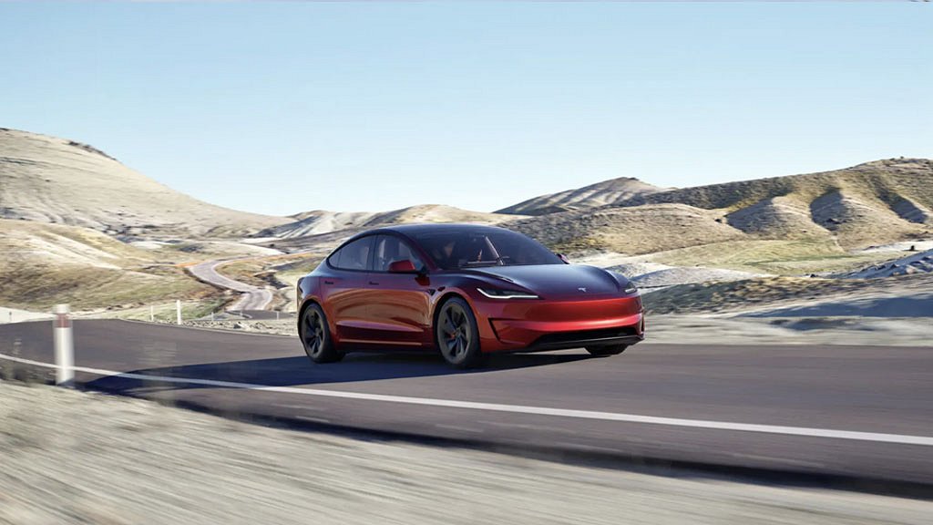 Röd tesla model 3 på väg