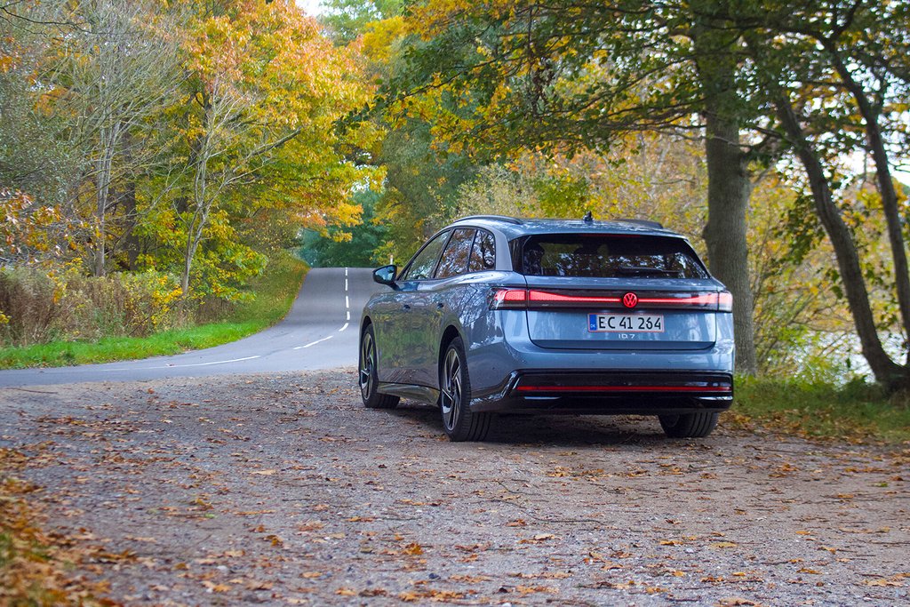 Baksidan av bilen på en landsväg som försvinner in i skogen.